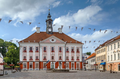 Buildings in town against sky