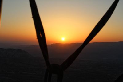 Scenic view of silhouette mountains against sky during sunset