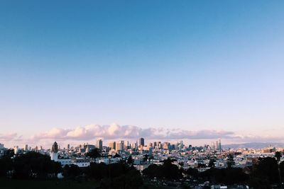 High angle view of cityscape against blue sky