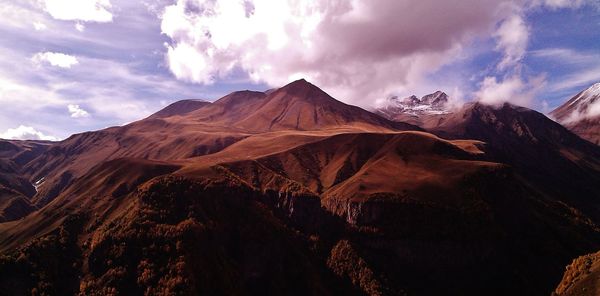 Scenic view of mountains against cloudy sky