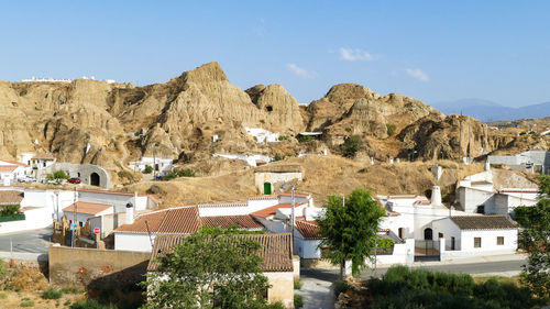 Buildings in town against sky