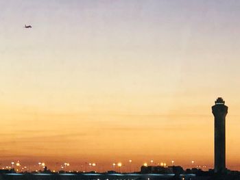 Silhouette buildings against sky during sunset in city