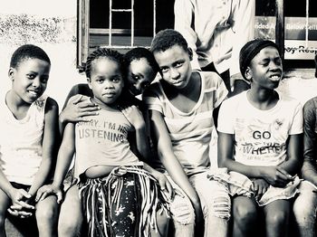 Portrait of friends sitting outdoors