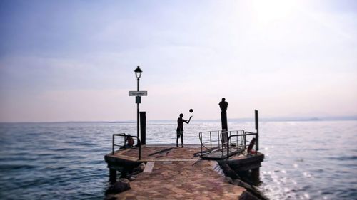 Man standing on sea against sky