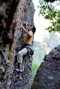 Portrait of man climbing rock face