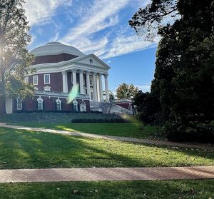 Lawn by building against sky