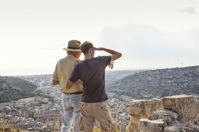 Father and son looking to scicli, sicily