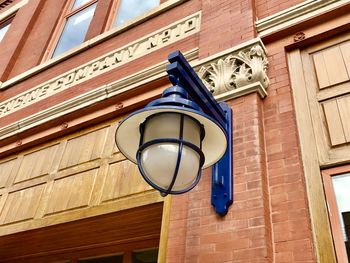 Low angle view of street light against building