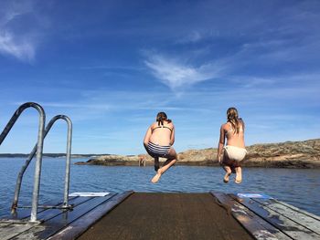 Rear view of two women at the seaside