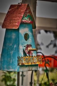 Low angle view of birdhouse on wooden wall