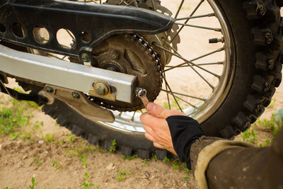 Close-up of man repairing wheel