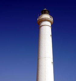 Low angle view of lighthouse against clear blue sky