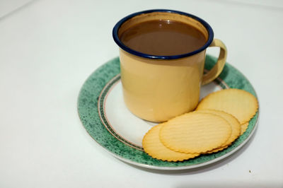 High angle view of coffee and cookies on table
