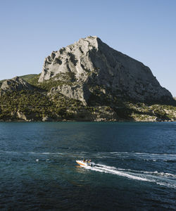 Scenic view of sea against clear blue sky