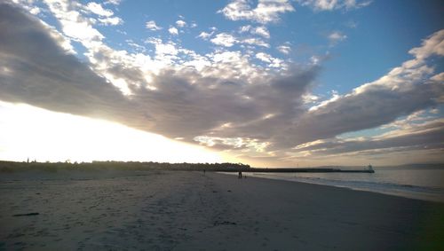 Scenic view of beach against sky during sunset