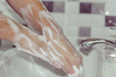 Close-up of human hand in bathroom