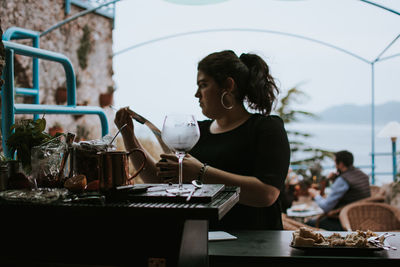 Woman and preparing food on table in kitchen