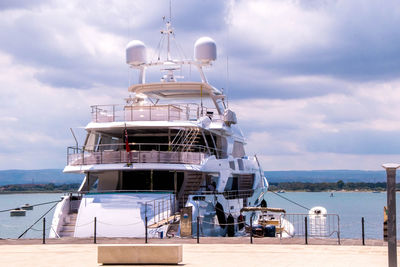 Ship moored in sea against sky