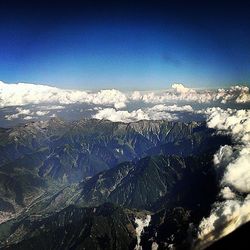 Scenic view of snow covered mountains against sky