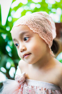 Close-up portrait of cute girl looking away