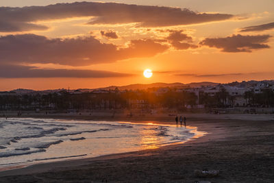 Scenic view of beach against sky during sunset