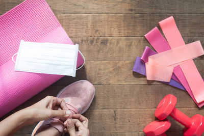 High angle view of hand holding paper at table