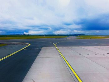 Airplane on runway against sky