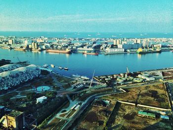 High angle view of cityscape by river against sky