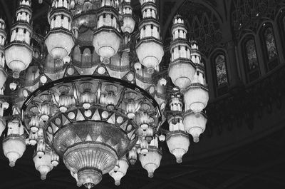 Low angle view of illuminated chandelier hanging in building