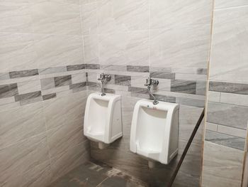 High angle view of urinals against wall in public toilet