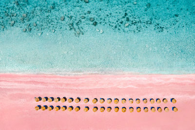 High angle view of sun umbrellas on pink beach by the sea