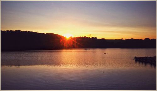 Scenic view of lake at sunset