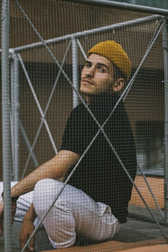 one person, adult, wire, wire mesh, chainlink fence, portrait, fence, building, prisoner, beard, prison, architecture, prison cell, social issues, looking at camera, mid adult, men, clothing