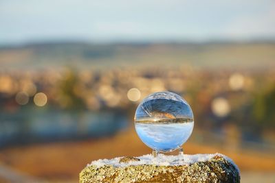 Close-up of crystal ball on rock