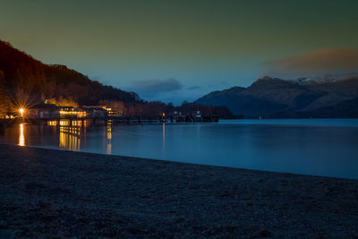 Scenic view of lake against sky at sunset