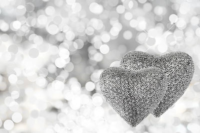 Close-up of heart shape decorations against defocused lights at night