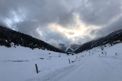 Scenic view of snow covered mountains against sky