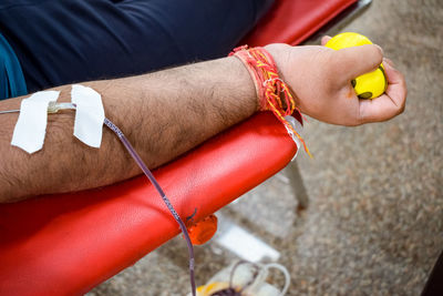 Blood donor at blood donation camp held with a bouncy ball holding in hand at balaji temple