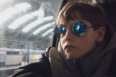 Portrait of boy looking through window