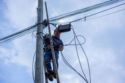 Low angle view of electricity pylon against sky