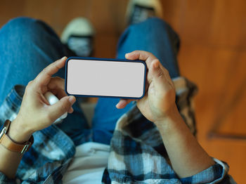 Midsection of man using mobile phone