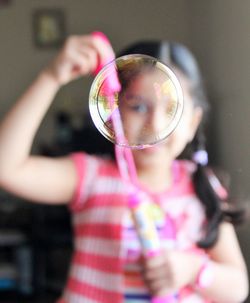 Close-up of girl holding reflection