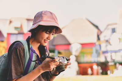 Close-up of woman photographing with camera in city