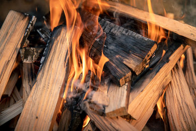 Pyre of burning wood with flames. charcoal for grilling meat. wood logs burn in the fireplace