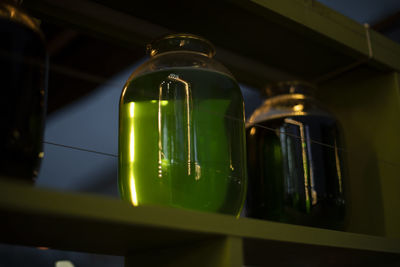 Jar with green liquid. transparent capacity. bar interior. acid liquid in glass containers.
