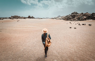 Rear view of woman walking on land