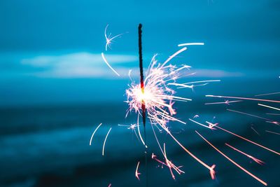Low angle view of firework display at night