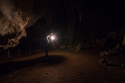 Man standing on rock at night