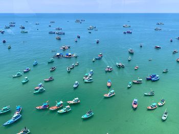 High angle view of sailboats moored on sea against sky