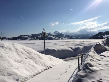 Snow covered landscape against sky